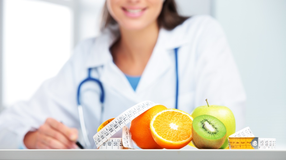 Nutritionist female Doctor in her office. Focus on fruit